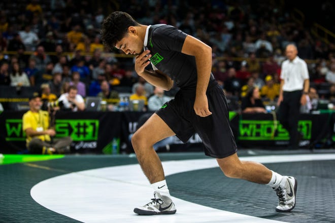 Richard Figueroa, of California, prays before a match at 113 pounds during Flowrestling's Who's Number One event, Saturday, Oct., 5, 2019, at Carver-Hawkeye Arena in Iowa City, Iowa.