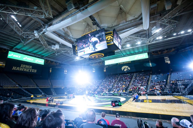 The flash of camera strobe lights illuminate the mat during Flowrestling's Who's Number One event, Saturday, Oct., 5, 2019, at Carver-Hawkeye Arena in Iowa City, Iowa.