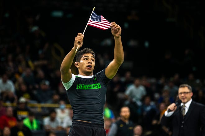 Shayne Van Ness, of New Jersey, celebrates waving an American flag after winning a match against Jesse Mendez (not pictured) at 132 pounds during Flowrestling's Who's Number One event, Saturday, Oct., 5, 2019, at Carver-Hawkeye Arena in Iowa City, Iowa.