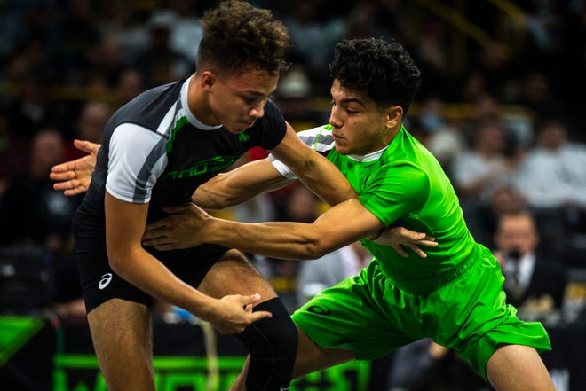 Jesse Ybarra, of Arizona, (green) wrestles Jakason Burks for a  3-1 win while wrestling at 120 pounds during Flowrestling's Who's Number One event, Saturday, Oct., 5, 2019, at Carver-Hawkeye Arena in Iowa City, Iowa.
