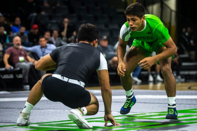 Shayne Van Ness, of New Jersey, (green) wrestles Dom Serrano, of Colorado, during a match at 132 pounds during Flowrestling's Who's Number One event, Saturday, Oct., 5, 2019, at Carver-Hawkeye Arena in Iowa City, Iowa.