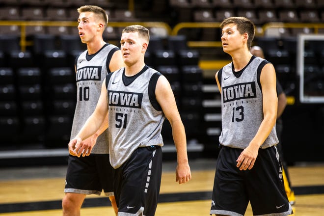 Iowa guards Joe Wieskamp, from left, Aidan Vanderloo, and  Austin Ash go for water break during an open practice following the Hawkeyes men's basketball media day, Wednesday, Oct., 9, 2019, at Carver-Hawkeye Arena in Iowa City, Iowa.