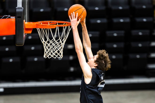 Iowa forward Patrick McCaffery (22) dunks during an open practice following the Hawkeyes men's basketball media day, Wednesday, Oct., 9, 2019, at Carver-Hawkeye Arena in Iowa City, Iowa.