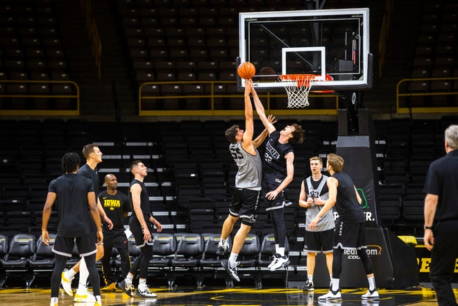 Iowa center Luka Garza (55) has his shot contested by Iowa forward Patrick McCaffery (22) during an open practice following the Hawkeyes men's basketball media day, Wednesday, Oct., 9, 2019, at Carver-Hawkeye Arena in Iowa City, Iowa.