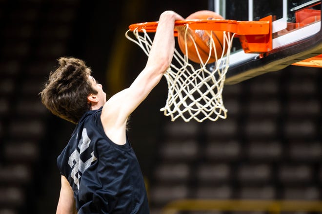 Iowa forward Patrick McCaffery (22) dunks during an open practice following the Hawkeyes men's basketball media day, Wednesday, Oct., 9, 2019, at Carver-Hawkeye Arena in Iowa City, Iowa.