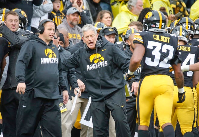 Iowa head football coach Kirk Ferentz greets his defense at the sideline after a Purdue fumble in the second quarter on Saturday, Oct. 19, 2019, at Kinnick Stadium in Iowa City.