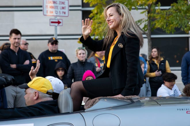 UI Provost Montse Fuentes waves to spectators during the University of Iowa Homecoming Parade on Friday, October 18, 2019 in Downtown Iowa City.