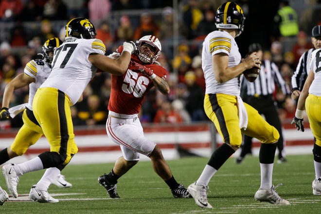 Badgers linebacker Zach Baun tries to get past Iowa offensive tackle Alaric Jackson on his way to quarterback Nate Stanley.