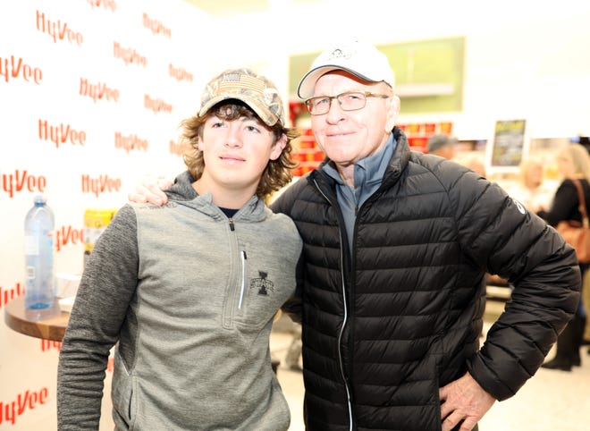 Ankeny Centennial freshman wrestler Zach Tew stops by for a photo with Dan Gable during a meet and greet with Iowa wrestling legend Dan Gable and a 3,000-pound wheel of aged white cheddar cheese sculpture of him on Sunday, Nov. 17, 2019, at the Hy-Vee, 410 N. Ankeny Blvd., in Ankeny.