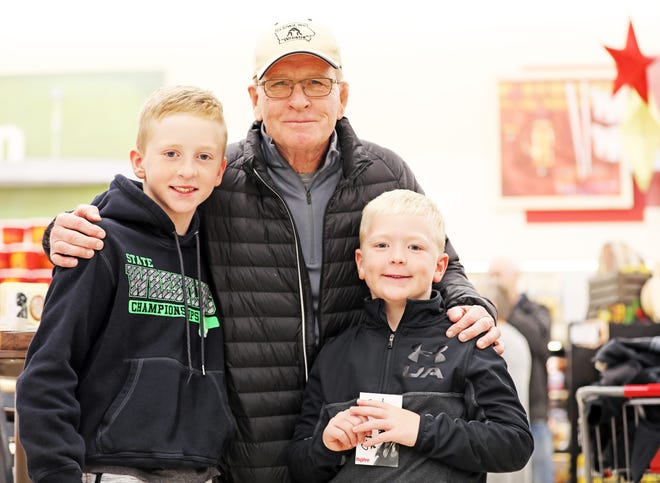 Dan Gable stops for a picture with young wrestlers, Dax, 11, and Cash Frey, 8, of Madrid during a meet and greet with Iowa wrestling legend Dan Gable and a 3,000-pound wheel of aged white cheddar cheese sculpture of him on Sunday, Nov. 17, 2019, at the Hy-Vee, 410 N. Ankeny Blvd., in Ankeny.