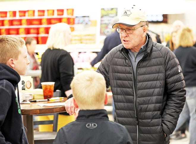 Dan Gable talks with young wrestlers, Dax, 11, and Cash Frey, 8, of Madrid during a meet and greet with Iowa wrestling legend Dan Gable and a 3,000-pound wheel of aged white cheddar cheese sculpture of him on Sunday, Nov. 17, 2019, at the Hy-Vee, 410 N. Ankeny Blvd., in Ankeny.