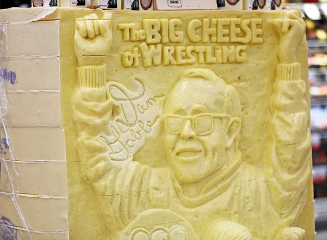 The honorary creation is on display during a meet and greet with Iowa wrestling legend Dan Gable and a 3,000-pound wheel of aged white cheddar cheese sculpture of him on Sunday, Nov. 17, 2019, at the Hy-Vee, 410 N. Ankeny Blvd., in Ankeny.
