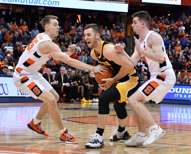 Dec 3, 2019; Syracuse, NY, USA; Iowa Hawkeyes guard Connor McCaffery (center) is caught between Syracuse Orange guard Buddy Boeheim (left) and guard Joseph Girard III (right) in the first half at the Carrier Dome. Mandatory Credit: Mark Konezny-USA TODAY Sports