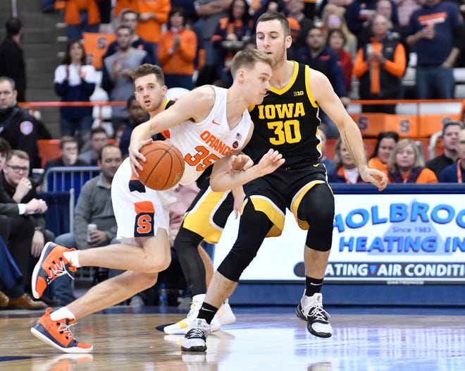 Dec 3, 2019; Syracuse, NY, USA; Syracuse Orange guard Buddy Boeheim (35) drives the ball past Iowa Hawkeyes guard Connor McCaffery (30) in the first half at the Carrier Dome. Mandatory Credit: Mark Konezny-USA TODAY Sports