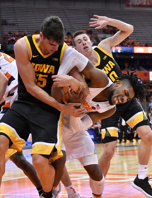 Dec 3, 2019; Syracuse, NY, USA; Syracuse Orange forward Quincy Guerrier (right) wrestles Iowa Hawkeyes center Luka Garza (55) for a rebound in the first half at the Carrier Dome. Mandatory Credit: Mark Konezny-USA TODAY Sports