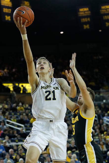 Michigan guard Franz Wagner goes to the basket on Iowa guard Jordan Bohannon in the first half in Ann Arbor, Friday, Dec. 6, 2019.