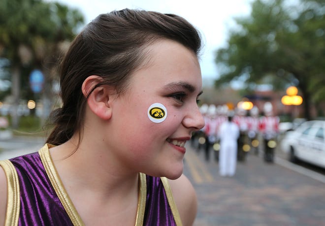 Fort Dodge sophomore Kiara Wilson, a flag performer in the Fort Dodge Marching Band, wears a Tigerhawk during the Outback Bowl parade on Tuesday, Dec. 31, 2013, in Tampa, Florida.