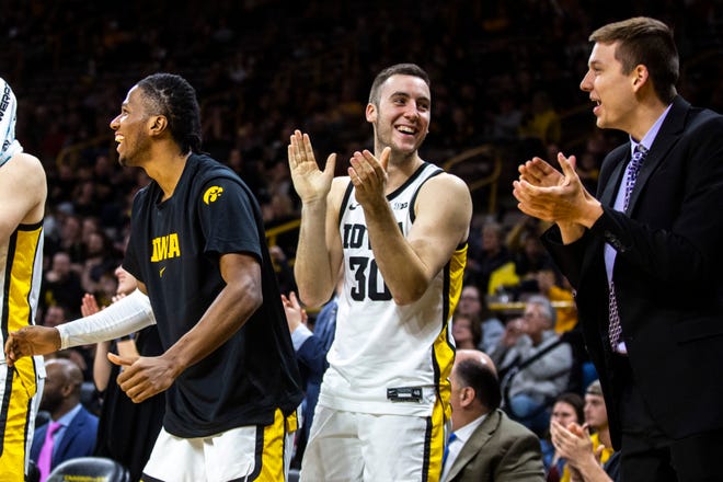 Iowa guard Connor McCaffery (30) celebrates with teammates Bakari Evelyn, left, and Austin Ash, right, during a NCAA college men's basketball game against Kennesaw State, Sunday, Dec. 29, 2019, at Carver-Hawkeye Arena in Iowa City, Iowa.