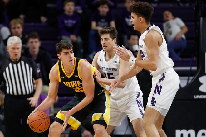 Jan 14, 2020; Evanston, Illinois, USA; Iowa Hawkeyes center Luka Garza (55) is defended by the Northwestern Wildcats during the first half at Welsh-Ryan Arena. Mandatory Credit: Kamil Krzaczynski-USA TODAY Sports
