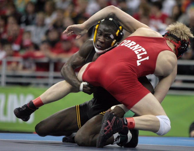 Iowa's Montell Marion takes a shot against Cornell's Kyle Dake in the 141-pound final of the 2010 NCAA Wrestling Championships in Omaha. Dake won 7-3.