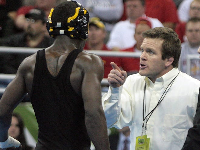 Iowa wrestling assistant coach Terry Brands, center, talks to Hawkeye Montell Marion after he defeated Pittsburgh's Tyler Nauman in their 141-pound semifinal match at the 2010 NCAA Wrestling Championships in Omaha.