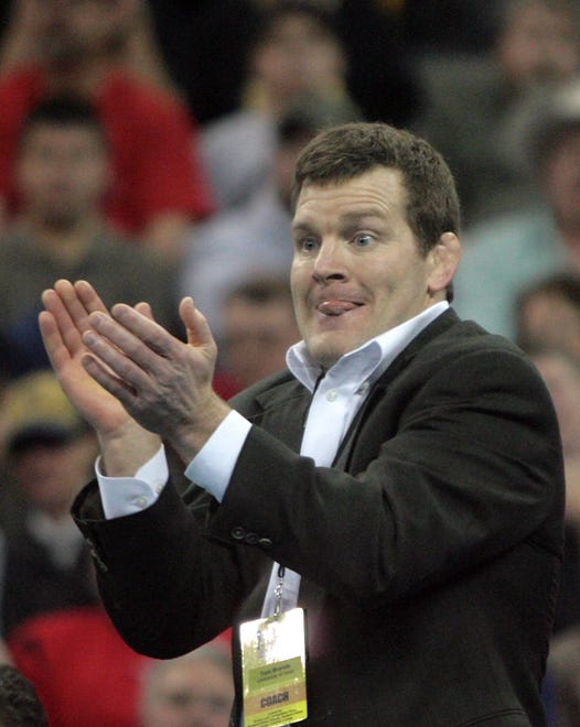 Iowa head coach Tom Brands cheers as Daniel Dennis wrestles Minnesota's Jayson Ness in the 133-pound final of the 2010 NCAA Wrestling Championships in Omaha. Ness won a 6-4 decision.