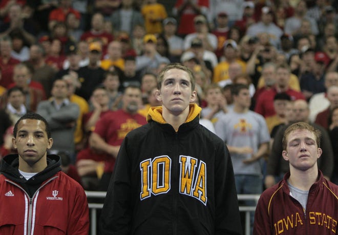 Iowa's Matt McDonough at the top of the medal stand after defeating Iowa State's Andrew Long (right) in the 125-pound final of the 2010 NCAA Wrestling Championships in Omaha. Angel Escobedo (left) of Indiana was third.