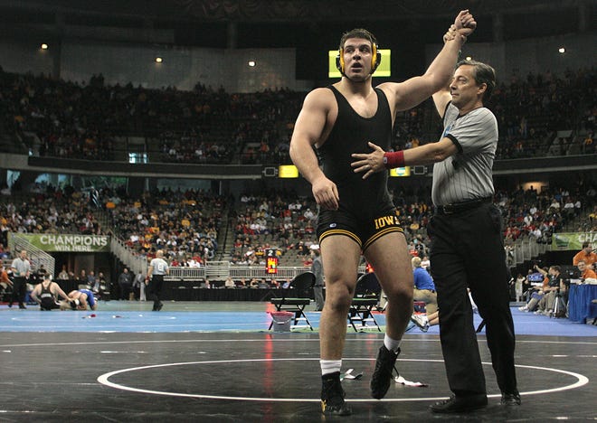 Iowa's Daniel Erekson has his arm raised after defeating Central Michigan's Jarod Trice in their 285-pound match for seventh place during the 2010 NCAA Wrestling Championships in Omaha.