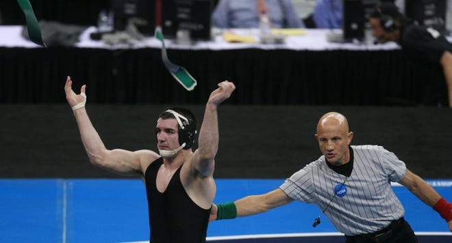 Iowa's Brent Metcalf celebrates after beating Ohio State's Lance Palmer in the 149-pound championship match during the 2010 NCAA Wrestling Championships in Omaha.