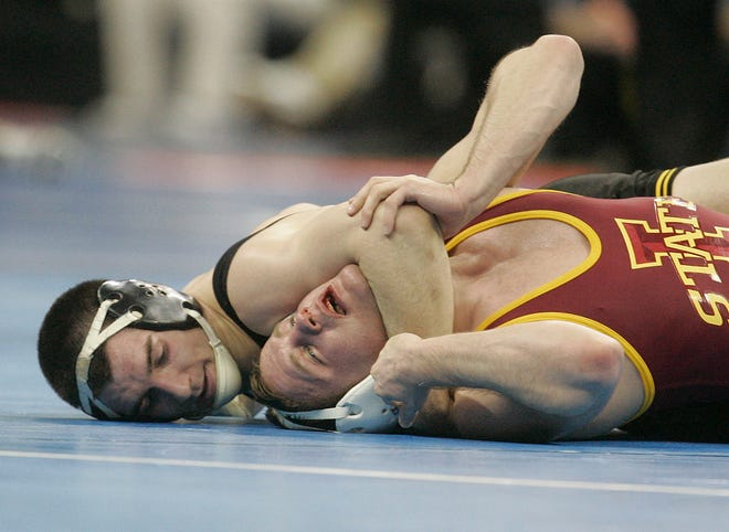Iowa's Brent Metcalf, left, beat Iowa State's Mitch Mueller, 16-4, in the quarterfinals of the 2010 NCAA Wrestling Championships in Omana on his way to a national title.