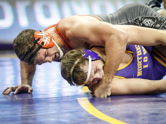 Northern Iowa's Nolan Glaser takes a hard cross face by Oklahoma State's Dakota Geer in their match at 197 pounds on Saturday, Jan. 25, 2020, at the McCleod Center in Cedar Falls.