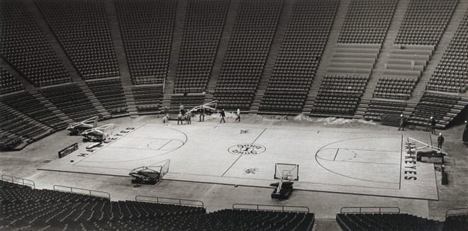 Crews put the final touches on the floor surface in this undated construction photo, at Carver-Hawkeye Arena in Iowa City, Iowa.