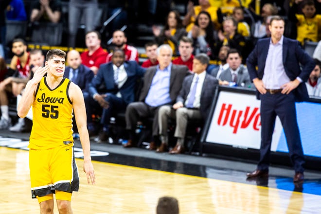 Iowa center Luka Garza (55) reacts after making 3-point basket while Nebraska head coach Fred Hoiberg, right, looks on during a NCAA Big Ten Conference men's basketball game, Saturday, Feb. 8, 2020, at Carver-Hawkeye Arena in Iowa City, Iowa.