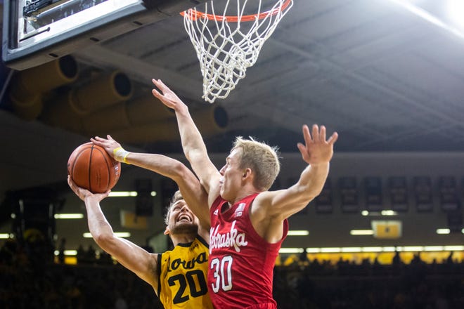 Iowa forward Riley Till (20) drives to the basket as Nebraska's Charlie Easley (30) defends during a NCAA Big Ten Conference men's basketball game, Saturday, Feb. 8, 2020, at Carver-Hawkeye Arena in Iowa City, Iowa.