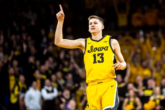 Iowa guard Austin Ash (13) reacts after making a 3-point basket during a NCAA Big Ten Conference men's basketball game against Nebraska, Saturday, Feb. 8, 2020, at Carver-Hawkeye Arena in Iowa City, Iowa.