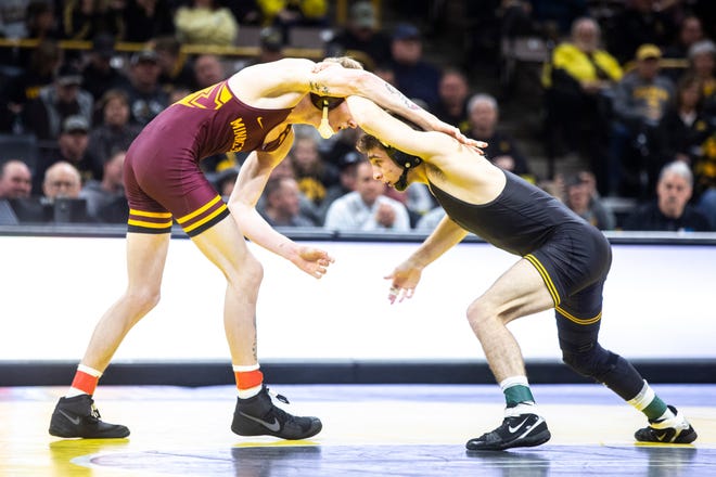 Iowa's Austin DeSanto, right, wrestles Minnesota's Boo Dryden at 133 pounds during a NCAA Big Ten Conference wrestling dual, Saturday, Feb. 15, 2020, at Carver-Hawkeye Arena in Iowa City, Iowa.