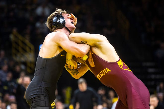 Iowa's Cash Wilcke, left, wrestles Minnesota's Owen Webster at 184 pounds during a NCAA Big Ten Conference wrestling dual, Saturday, Feb. 15, 2020, at Carver-Hawkeye Arena in Iowa City, Iowa.
