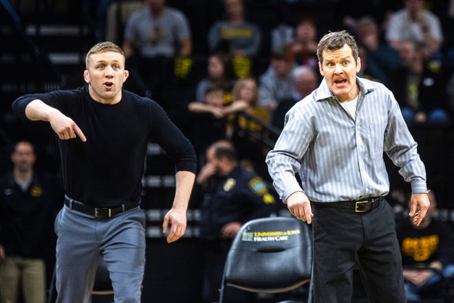 Iowa assistant coach Ryan Morningstar, left, and head coach Tom Brands call out instructions to a wrestler during a NCAA Big Ten Conference wrestling dual, Saturday, Feb. 15, 2020, at Carver-Hawkeye Arena in Iowa City, Iowa.