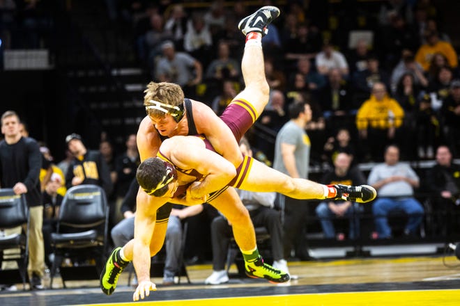 Iowa's Jacob Warner, top, wrestles Minnesota's Hunter Ritter at 197 pounds during a NCAA Big Ten Conference wrestling dual, Saturday, Feb. 15, 2020, at Carver-Hawkeye Arena in Iowa City, Iowa.