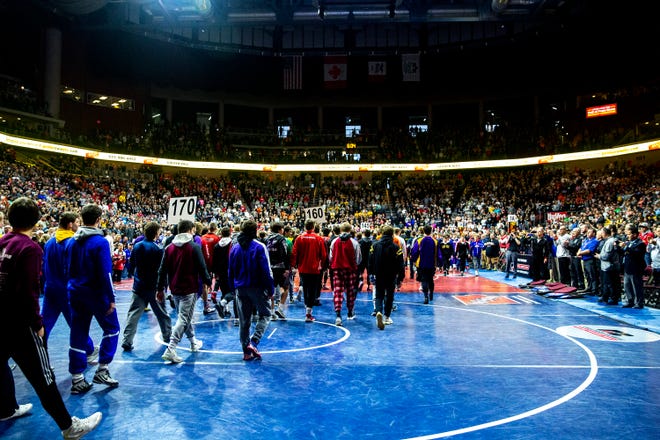 Wrestlers march into Wells Fargo Arena before the Iowa high school state wrestling tournament on Saturday, Feb. 22, 2020, at Wells Fargo Arena, in Des Moines.