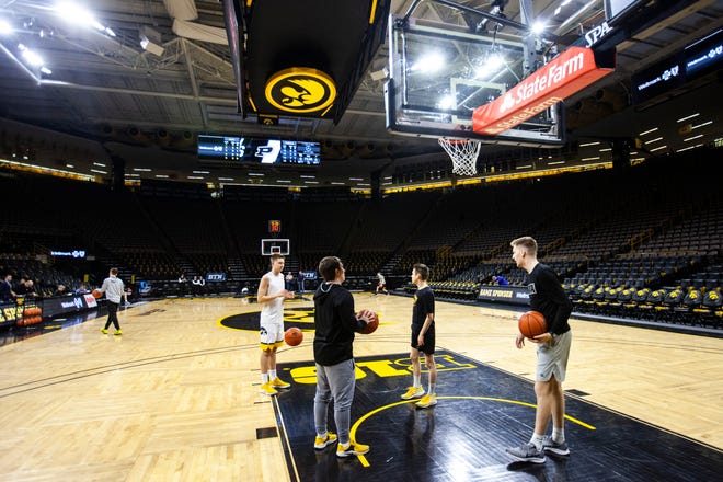 Iowa guard Austin Ash warms up with help from managers before a NCAA Big Ten Conference men's basketball game against Purdue, Tuesday, March 3, 2020, at Carver-Hawkeye Arena in Iowa City, Iowa.