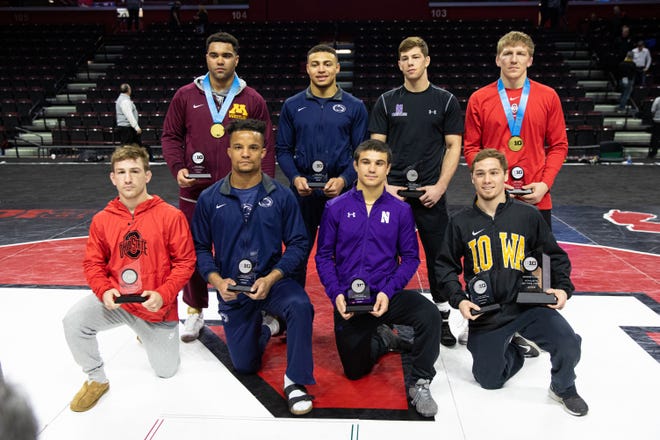 Iowa's Spencer Lee, first row, far right, poses with his trophies after winning his first Big 10 title. Lee was named the conference Wrestler of the Year.