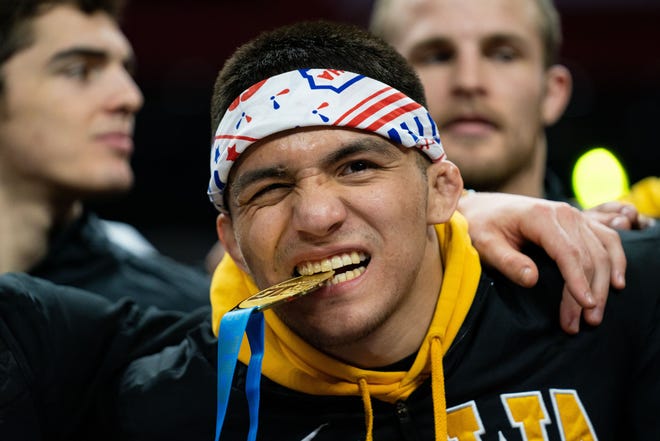 Iowa wrestler Pat Lugo poses after defeating Ohio State's Sammy Sasso to win the 149-pound title at the Big 10 Wrestling Championships.