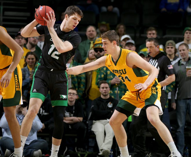 SIOUX FALLS, SD - MARCH 10: Filip Rebraca #12 of the North Dakota Fighting Hawks looks to make a move against Rocky Kreuser #34 of the North Dakota State Bison during the men’s championship game at the 2020 Summit League Basketball Tournament in Sioux Falls, SD. (Photo by Dave Eggen/Inertia)
