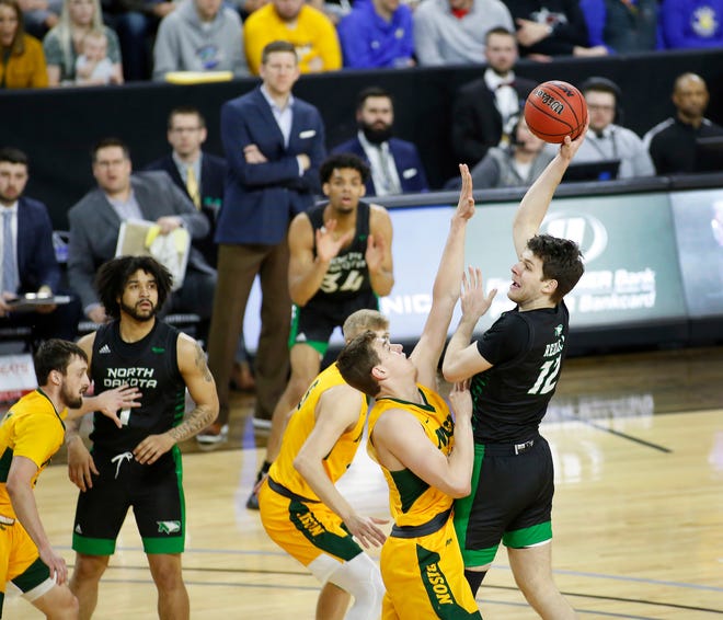 SIOUX FALLS, SD - MARCH 10: Filip Rebraca #12 of the North Dakota Fighting Hawks shoots over a North Dakota State defender during the men’s championship game at the 2020 Summit League Basketball Tournament in Sioux Falls, SD. (Photo by Richard Carlson/Inertia)