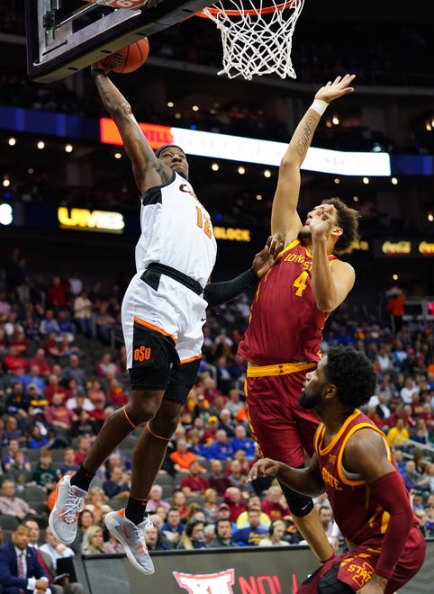 Oklahoma State Cowboys forward Cameron McGriff (12) dunks against Iowa State Cyclones forward George Conditt IV (4) and guard Tre Jackson (3) during the first half at Sprint Center on March 11, 2020.
