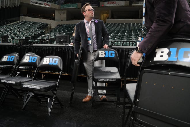 Staff member Joseph Hamata removes seating after the Michigan Wolverines vs. Rutgers Scarlet Knights first round Big Ten tournament game at Bankers Life Fieldhouse in Indianapolis was canceled due to the Coronavirus Pandemic on Thursday, March 12, 2020.
