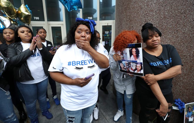 Bianca Austin tried to compose herself before making remarks during a vigil for her niece, Breonna Taylor, outside the Judicial Center in downtown Louisville, Ky. on Mar. 19, 2020.  Taylor was shot and killed by LMPD officers last week. The family chose the vigil site because it is across the street from the Louisville Metro Police Department.