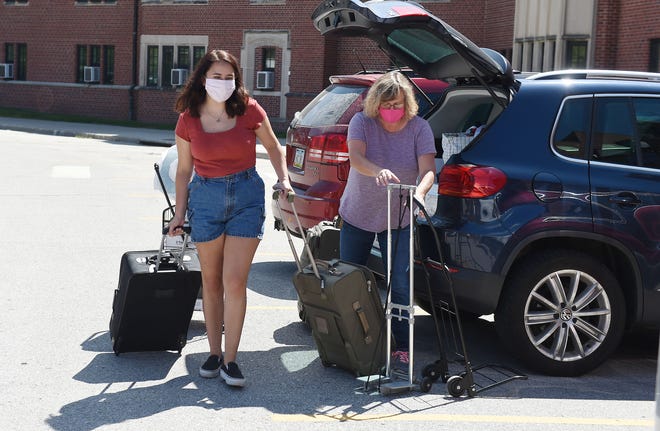 Iowa State University freshman Emma Lutz from Illinois gets help her mother Kim Lutz, during moving in her dorm at Eaton Residence Hall Monday, Aug. 3, 2020, in Ames, Iowa. Photo by Nirmalendu Majumdar/Ames Tribune