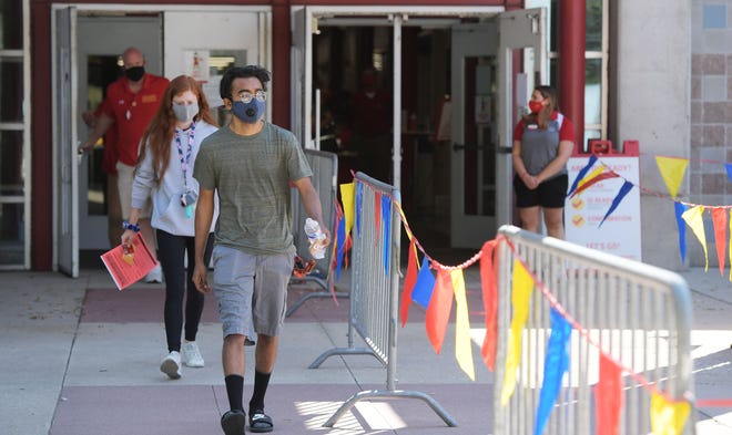 Iowa State University students come out from the Lied Athletic Recreation Center after testing COVID-19 before they move-in their dorm Monday, Aug. 3, 2020, in Ames, Iowa. Photo by Nirmalendu Majumdar/Ames Tribune